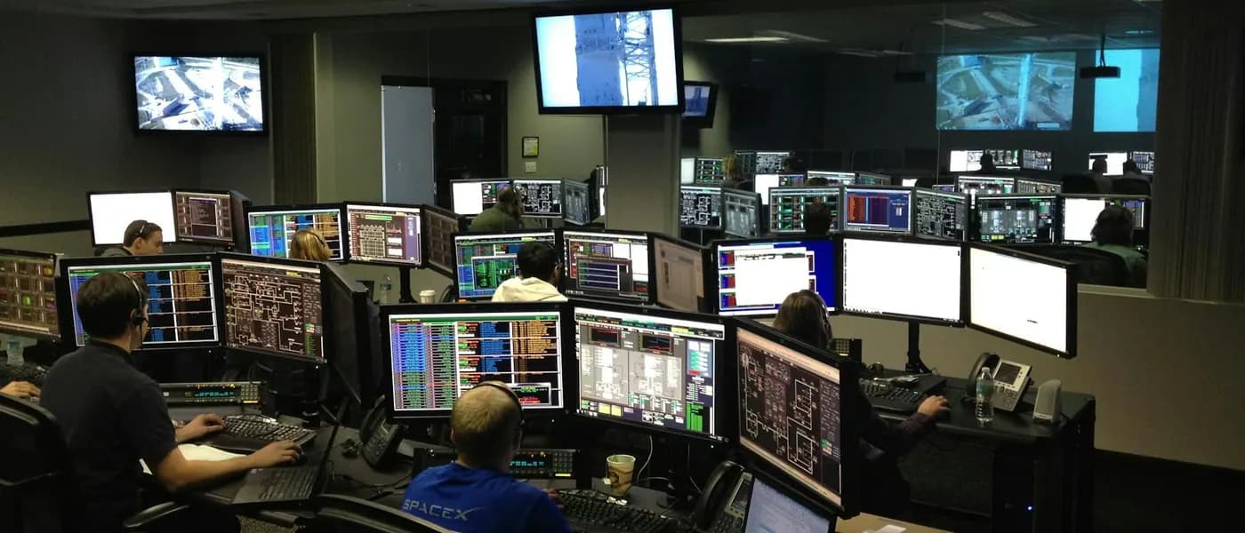 Network operations center with engineers monitoring multiple screens for managed IT support