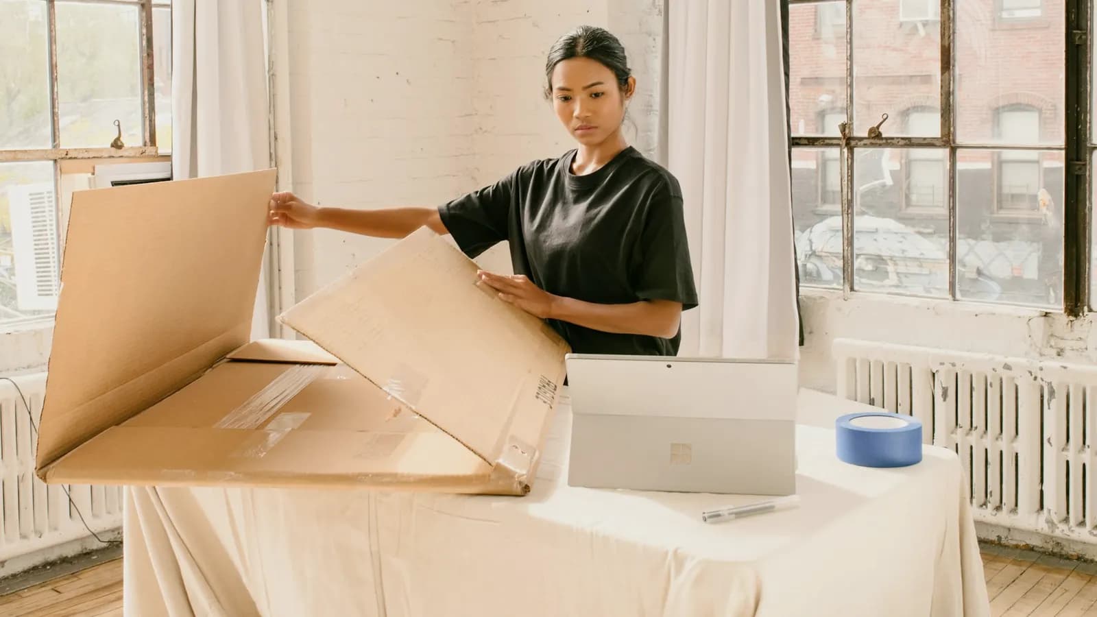 Employee unpacking a new laptop at home as part of a device refresh